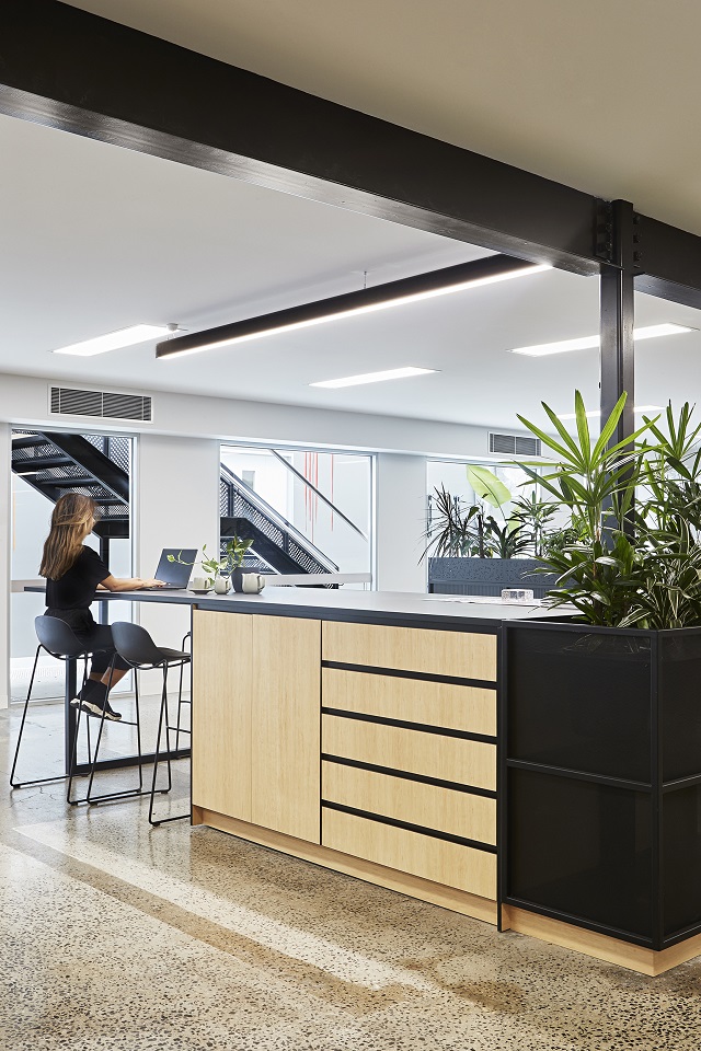Image of a woman working in a breakout space.