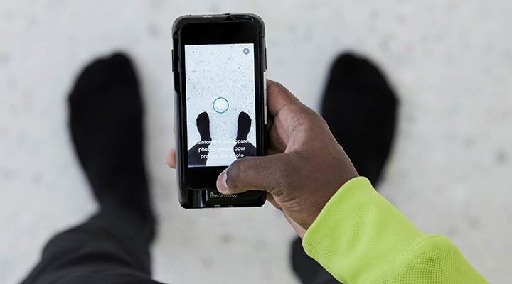 A man holding a smartphone with a Nike app open.
