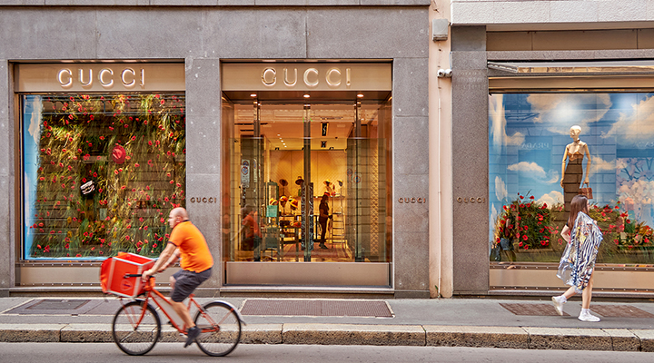 A cyclist rides outside the Gucci store in Milan.