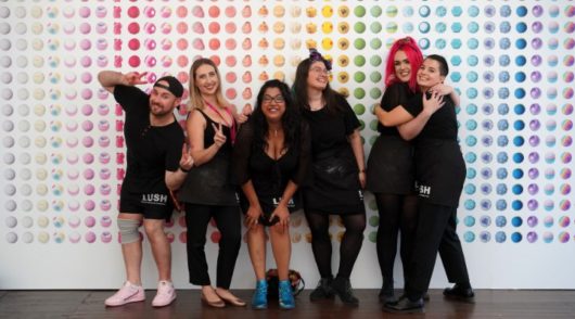 A group of happy people wearing black clothes