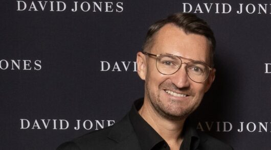 David Jones CMO James Holloman in front of a black and white media wall in 2024