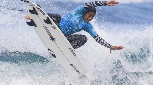 a man wearing Rip Curl's blue long sleeve surfing shirt