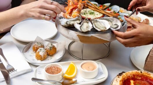seafood, dips and pizza on dining table