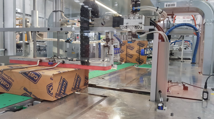 An image of cardboard boxes on a conveyor belt with Catch branding.