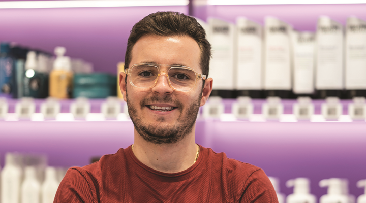 Image of Oz Hair & Beauty COO Guy Nappa taken in a story with purple shelving in the background