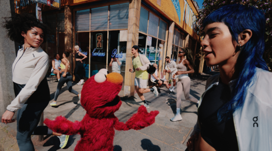 A campaign image from the running brand On featuring the Sesame Street character Elmo