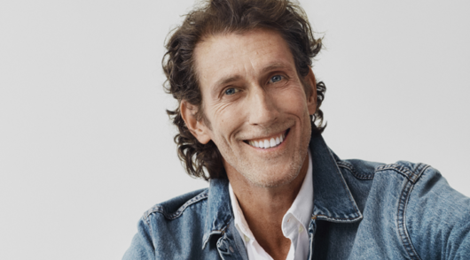 a headshot of gap inc ceo richard dickson wearing a denim jacket and white collared shirt