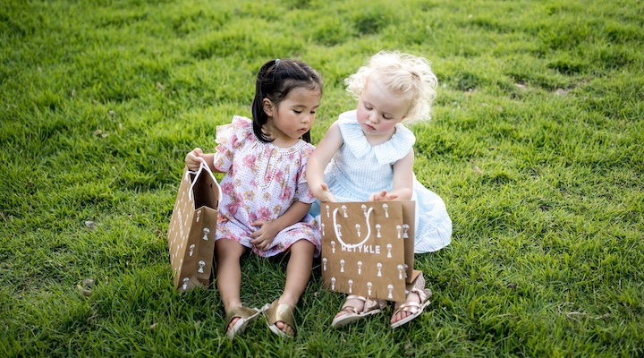 Two young childen with Retykle packaging