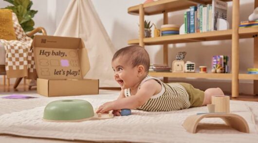 A photo of a baby on a beige carpet playing with toys