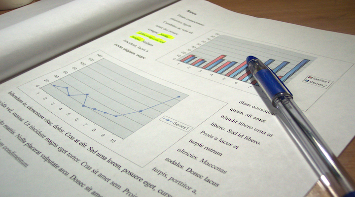 Image of graphs on paer and a pen.