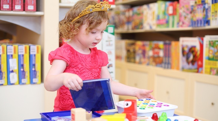 Girl playing in a toy store.