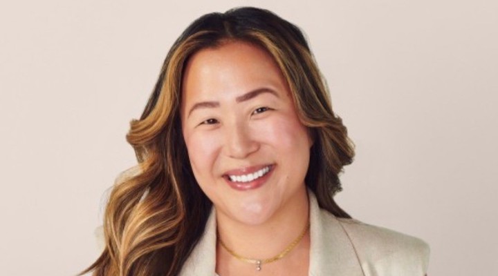 A headshot of Dagne Dover CEO Melissa Mash against a beige background.