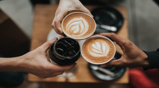 Image of people holding coffees.