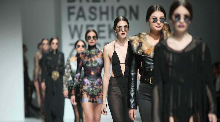 Image of models walking on a ramp.