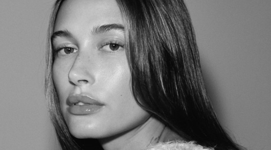 a closeup of rhode founder hailey bieber in black and white