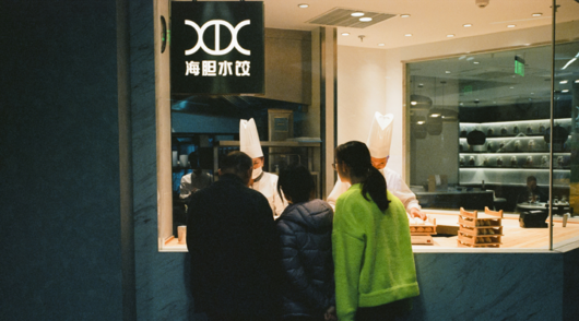 people standing in front of a shop window in china