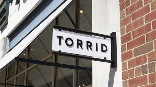 A close-up of a Torrid storefront in Carmel, Indiana.