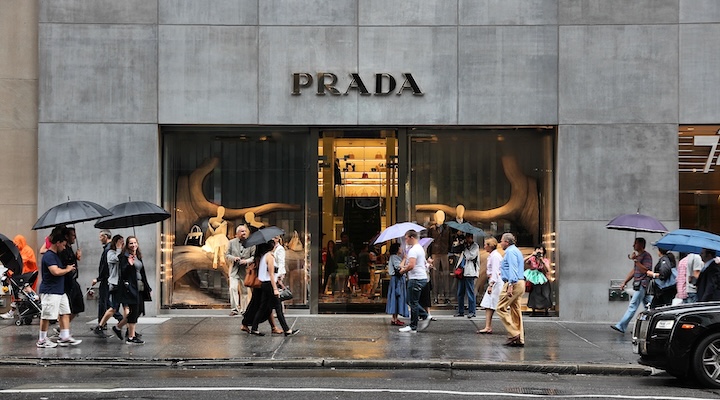 People walk by Prada shop
