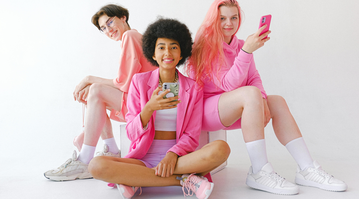 A trio of young people holding smartphones
