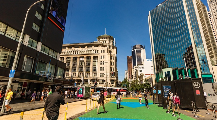 people walk on a street in Auckland