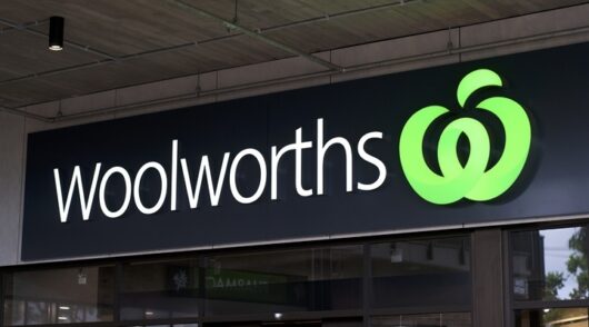 Image of Woolworths logo on building.