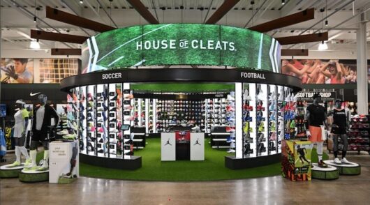 An interior shot of a Dick’s Sporting Goods store featuring a display showcasing various sports footwear.