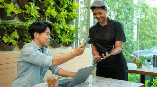 Customer paying bill through smartphone using NFC