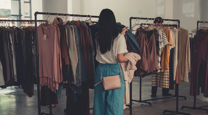 a woman shopping a clothes rack