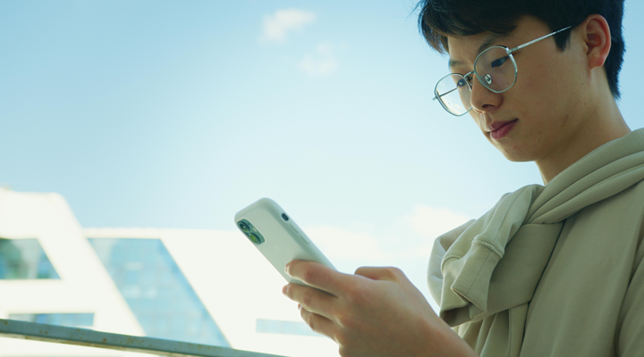 Man Wearing Eyeglasses Using Cellphone