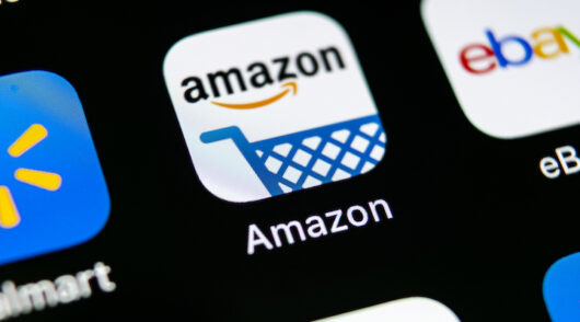 A close-up of a smartphone, zooming in on the Amazon app.