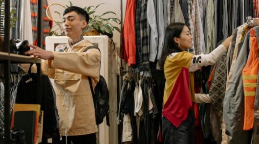 Two customers looking at clothes
