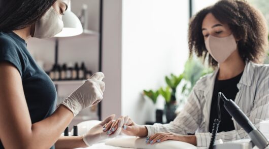 Image of woman getting her nails done at a salon.