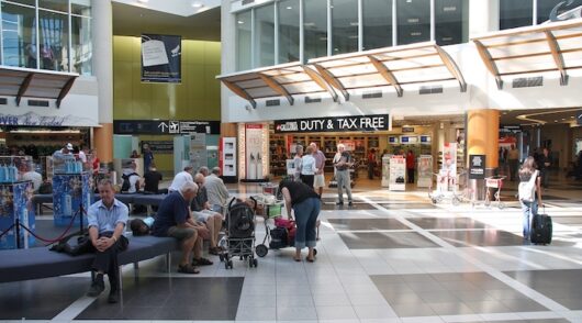 People wait at Christchurch Airport in New Zealand