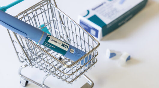 Ozempic placed in a miniature shopping cart.