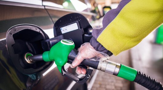man pumps fuel into car