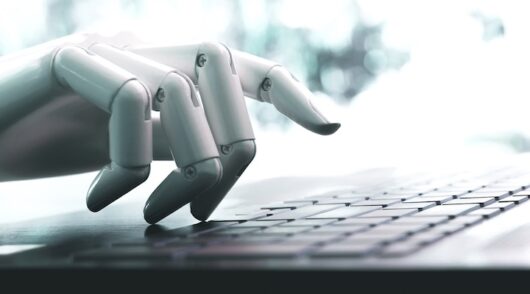 Robot concept or robot hand chatbot pressing computer keyboard