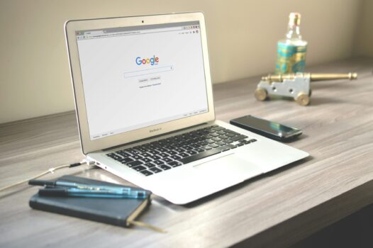 Laptop showing Google homepage.