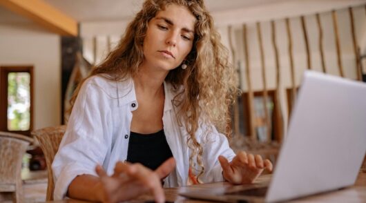 Woman in white blazer working