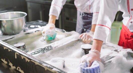 staff cleaning restaurant kitchen