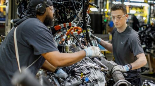Ford workers assemble a vehicle.