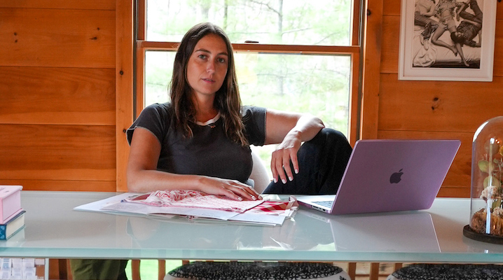 Cozyland founder Morgan Lane sitting at a desk in front of a window.