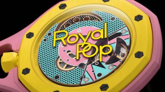 A close-up shot of a Royal Pop yellow and pink pocketwatch.