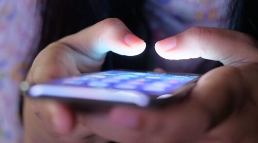 A close-up shot of hands holding a smartphone