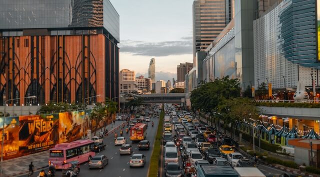 cityscape of Bangkok at dusk with bustling traffic and skyline in view