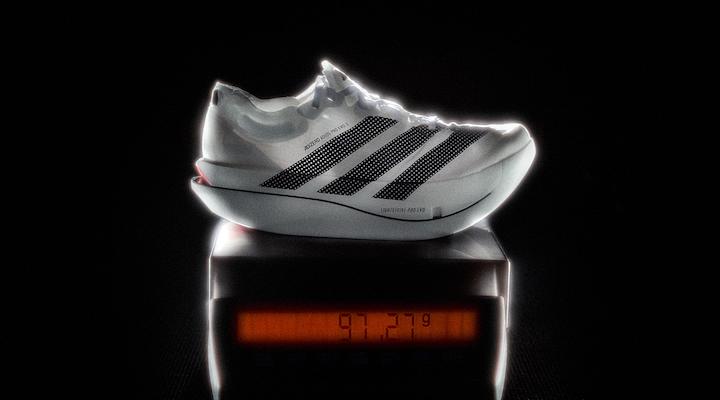 A white and black Adidas against a black background.